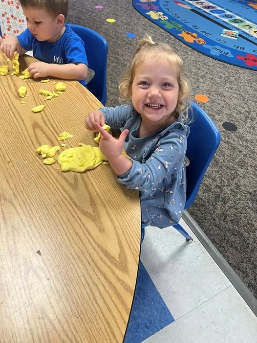 Happy child playing with playdough