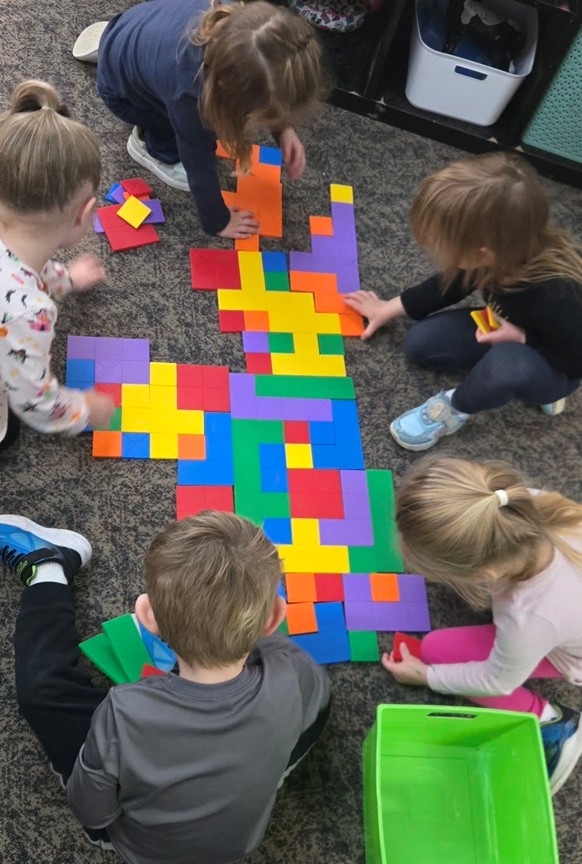 Children working together with colorful puzzle blocks