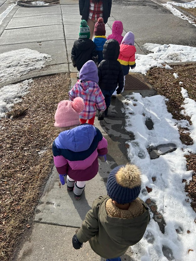 Children bundled up on a winter walk